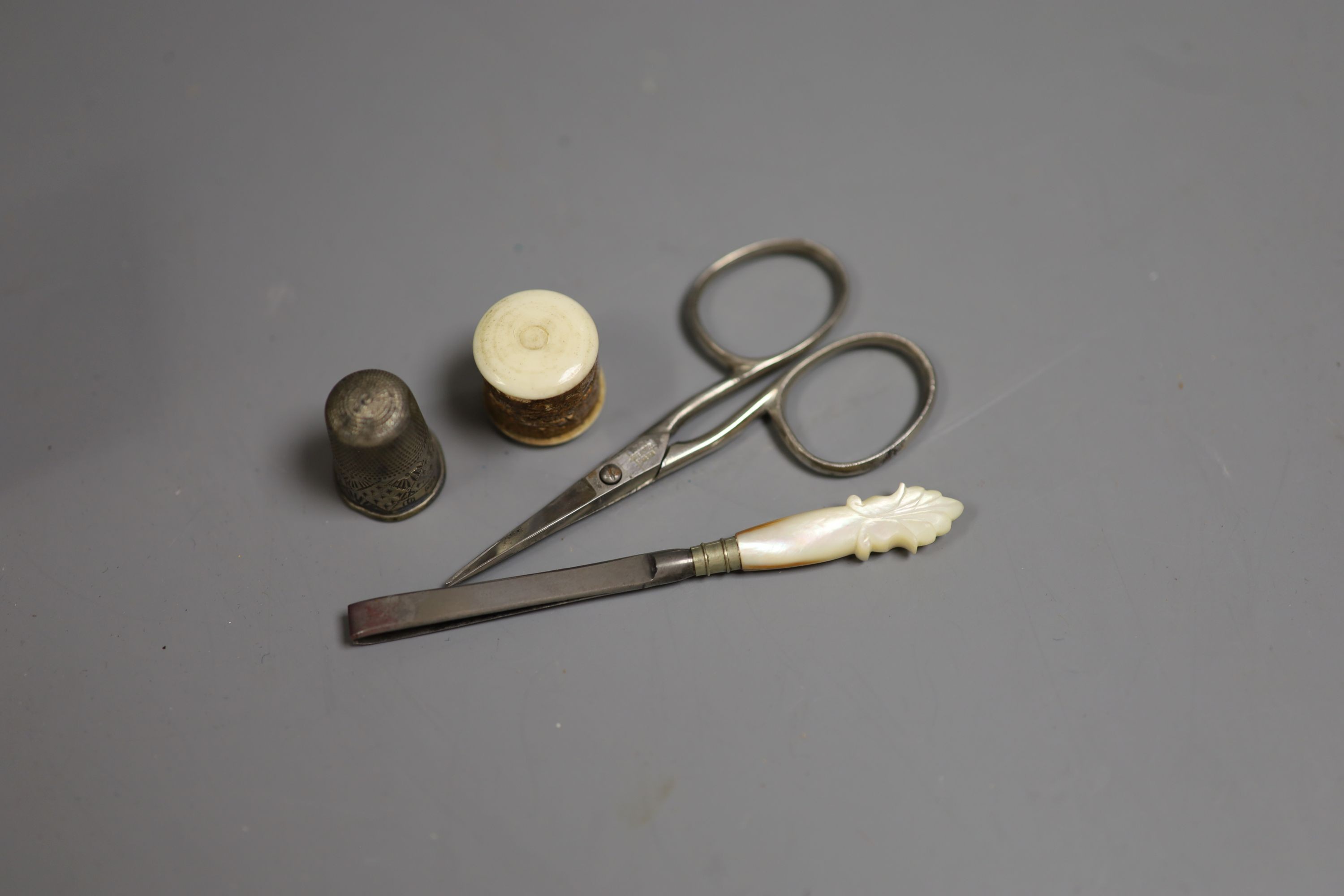 A tooled leather ‘lady's companion’ necessaire set, 9cm high, 4cm wide